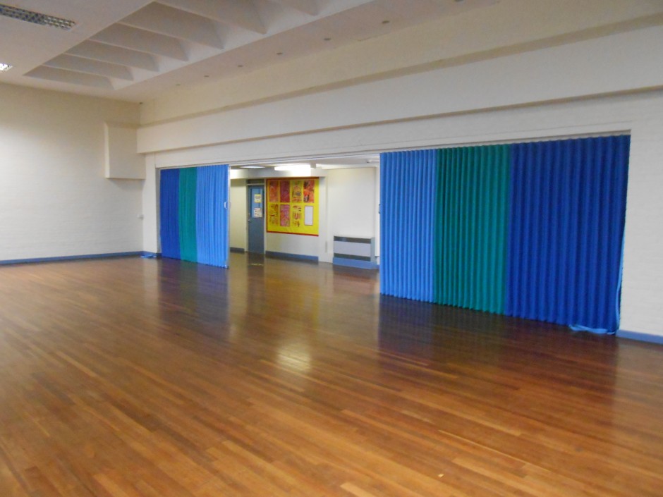 blue folding sliding room partitions in a school hall.