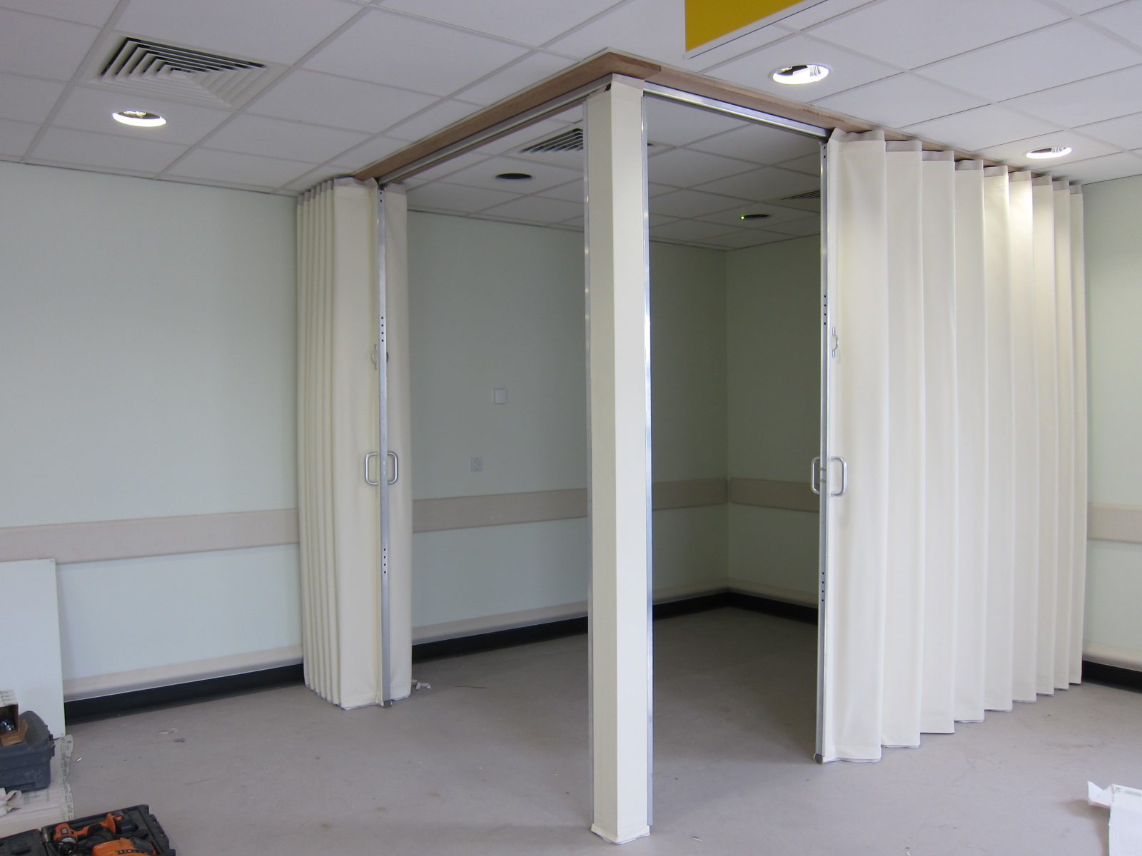 white concertina folding wall used to create a corner room Bristol - Building Additions