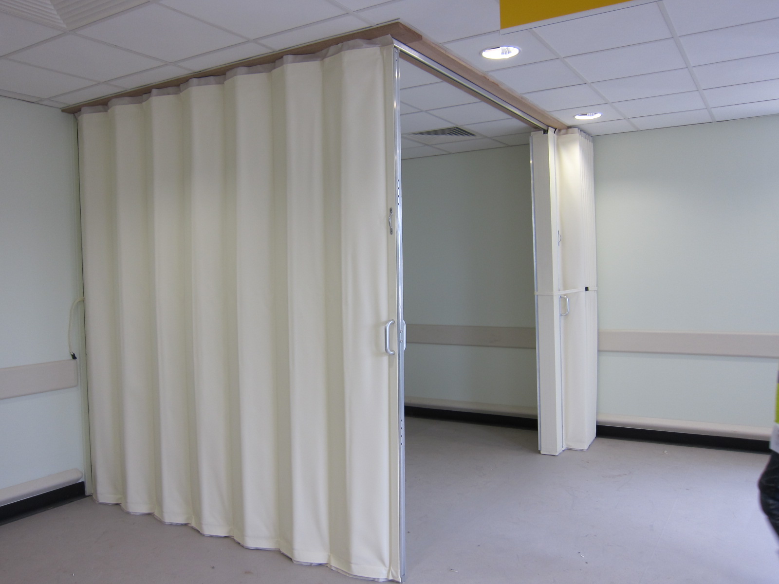 white concertina folding wall used to create a corner room Bristol - Building Additions