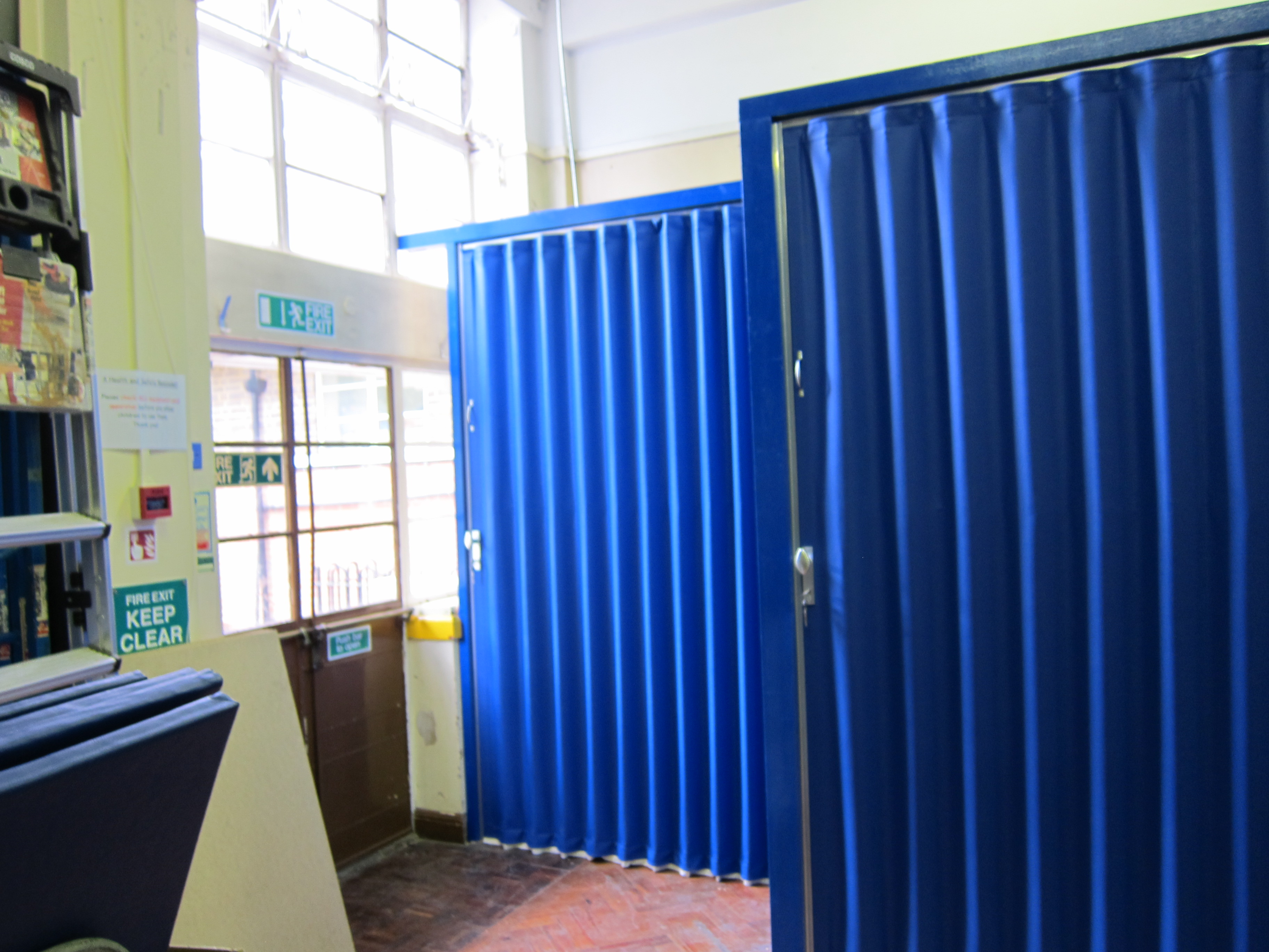blue folding walls shown creating a temporary corridor in a school in Bristol